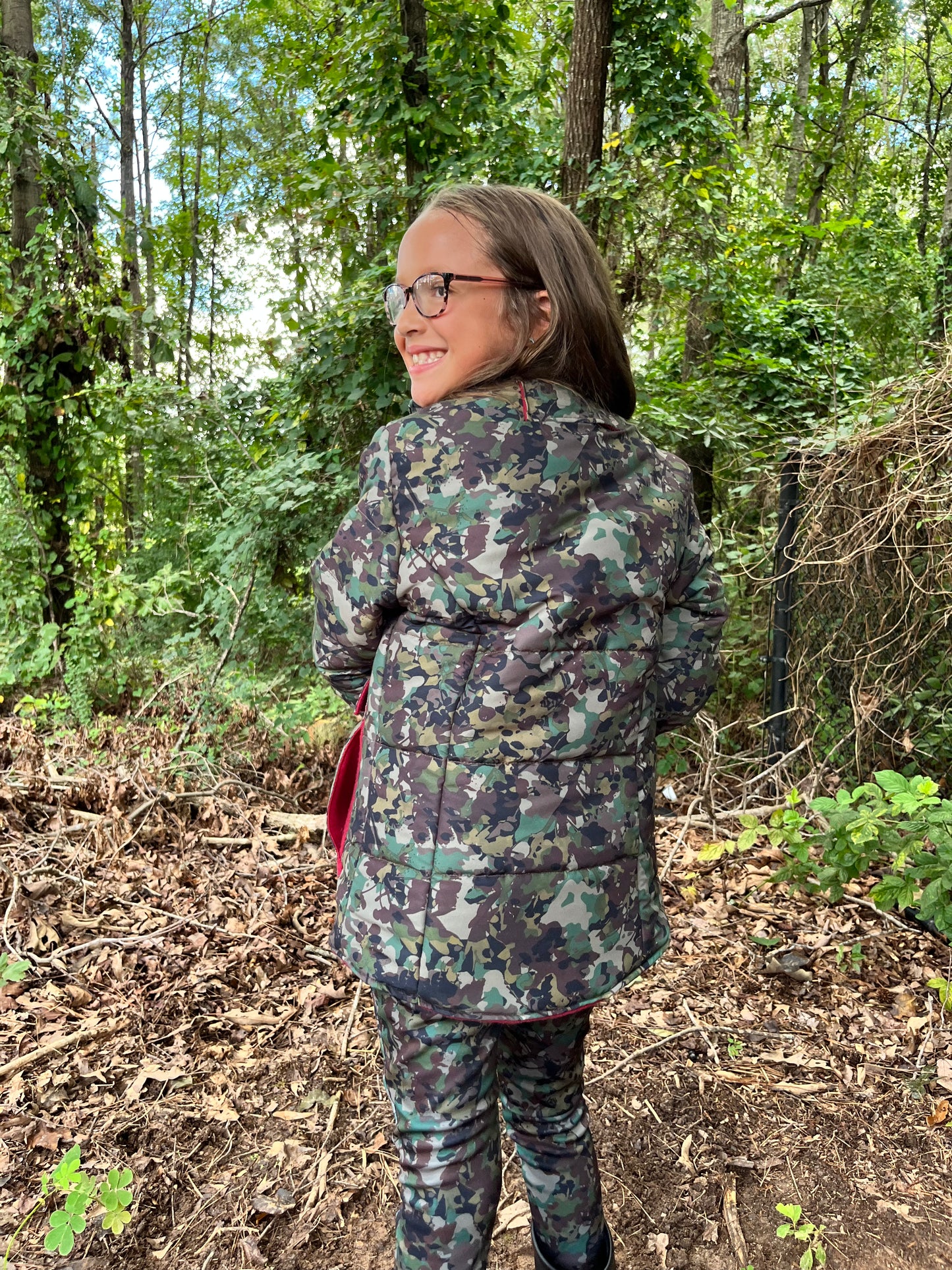 girl wearing camo hunting jacket with harness pass through