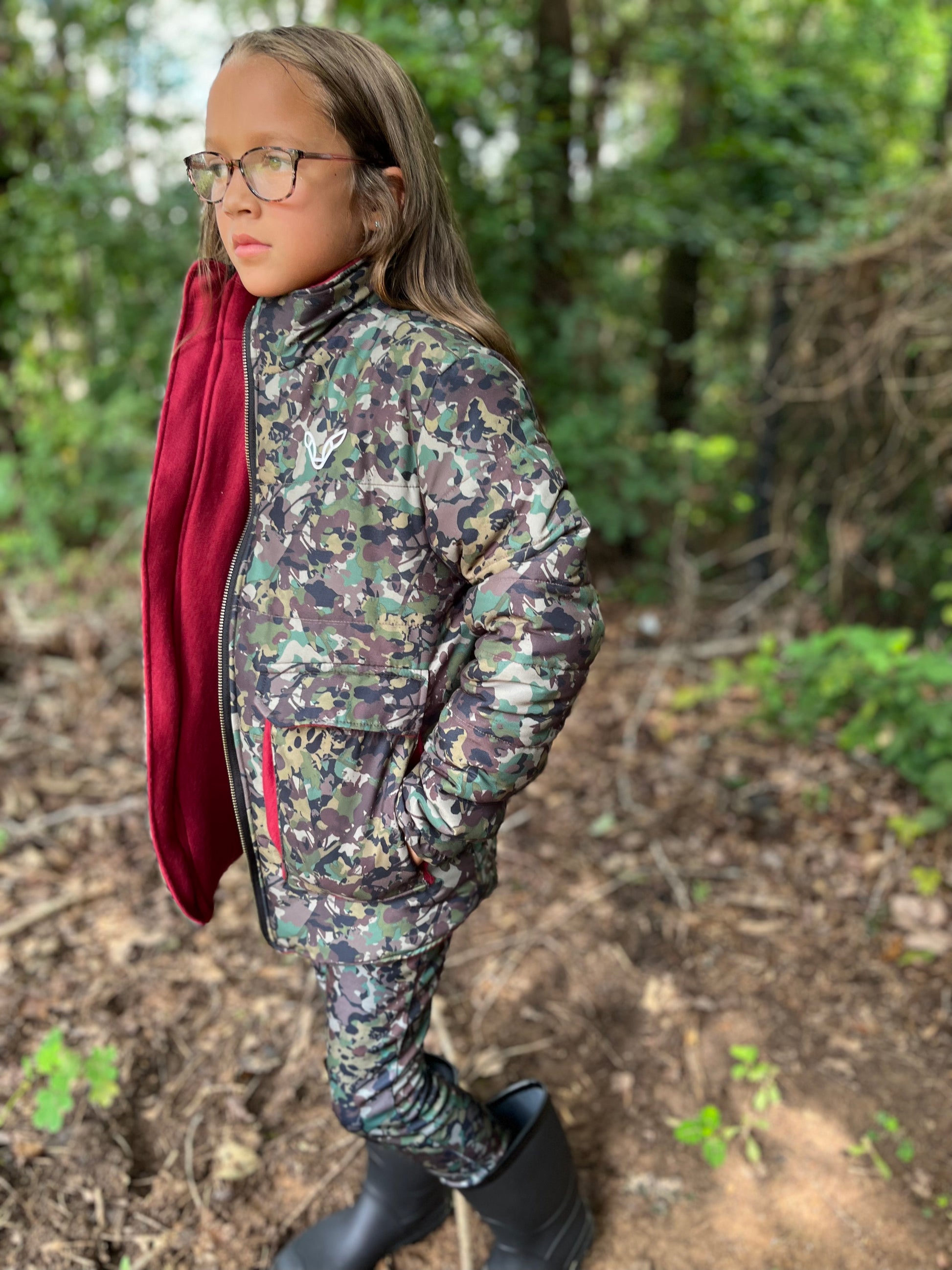 Girl wearing camo hunting jacket and camo hunting pants